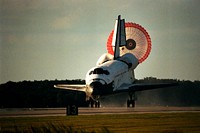 The orbiter drag chute deploys after the Space Shuttle orbiter Atlantis lands on Runway 15 of the KSC Shuttle Landing Facility at the conclusion of the nearly 11-day STS-86 mission, Oct. 6, 1997. Original from NASA. Digitally enhanced by rawpixel.