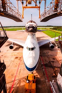 KENNEDY SPACE CENTER, FLA. -- The Boeing 747 Shuttle Carrier Aircraft is cast in morning shadows as it backs away from the Mate/Demate Device with the orbiter Columbia strapped to its back. April 10th, 2012. Original from NASA . Digitally enhanced by rawpixel.