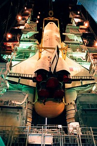 Lights frame the orbiter Endeavour as it is lowered onto the platform for mating with the external tank and solid rocket boosters. Original from NASA . Digitally enhanced by rawpixel.
