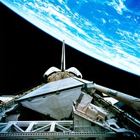 The payload bay of the orbiting space shuttle Endeavour with an area of the Pacific Ocean northeast of Hawaii in the background. Original from NASA . Digitally enhanced by rawpixel.