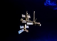 Following undocking from the Space Shuttle Atlantis, Russia's Mir Space Station is backdropped against dark blue water on Earth. Original from NASA. Digitally enhanced by rawpixel.
