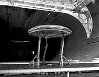 Avrocar Test in Ames 40x80 Foot Wind Tunnel. Rear view of the Avrocar with tail, mounted on variable height struts. Overhead doors of the wind tunnel test section open. Apr 3rd, 1961. Original from NASA. Digitally enhanced by rawpixel.
