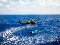 Astronaut Alan B. Shepard Jr. is rescued by a U.S. Marine helicopter at the termination of his suborbital flight May 5, 1961. Original from NASA. Digitally enhanced by rawpixel.