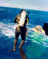 Frogman dives into the water to aid the recovery of Gemini 5. Original from NASA. Digitally enhanced by rawpixel.