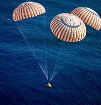 The Apollo 17 Command Module (CM), with astronauts Eugene A. Cernan, Ronald E. Evans and Harrison H. Schmitt aboard, nears splashdown in the South Pacific Ocean. Original from NASA. Digitally enhanced by rawpixel.