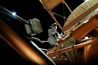Astronaut participates in EVA to deploy twin polar shield. Original from NASA . Digitally enhanced by rawpixel.