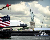 The space shuttle Enterprise, atop a barge, passes the Statue of Liberty in New York. Original from NASA . Digitally enhanced by rawpixel.