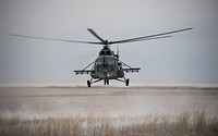A Russian search and rescue helicopter arrives at the Soyuz TMA-13M spacecraft landing site, 2014-11-10. Original from NASA. Digitally enhanced by rawpixel.