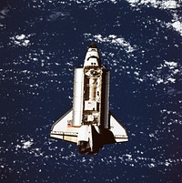 The Space Shuttle Discovery approaches Russia's Mir space station in this 70mm photograph taken from the Mir. Original from NASA. Digitally enhanced by rawpixel.