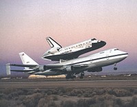 The space shuttle Atlantis atop NASA's 747 Shuttle Carrier Aircraft (SCA) during takeoff for a return ferry flight to the Kennedy Space Center from Edwards, California. 1994. Original from NASA. Digitally enhanced by rawpixel.