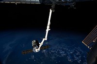 The International Space Station&rsquo;s Canadarm2 prepares to release the Orbital Sciences&#39; Cygnus commercial cargo craft after a month visiting the orbital outpost. Original from NASA . Digitally enhanced by rawpixel.
