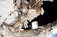 Astronauts working outside the space station&#39;s Quest airlock in Oct 7, 2014. Original from NASA . Digitally enhanced by rawpixel.
