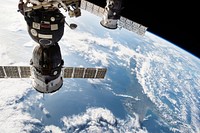 The Soyuz TMA-15M spacecraft on the left attached to the Rassvet module on the Earth-facing port of the Russian segment of the station Nov 24th, 2014. Original from NASA . Digitally enhanced by rawpixel.