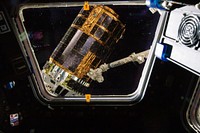 International Space Station&rsquo;s Canadarm2 grapples the unpiloted Japan Aerospace Exploration Agency (JAXA) H-II Transfer Vehicle (HTV-3) as it approaches the station. July 27th, 2012. Original from NASA . Digitally enhanced by rawpixel.