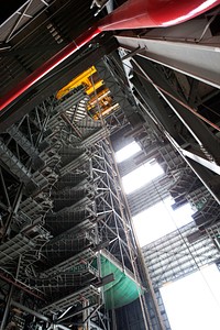 In this view looking up in the Vehicle Assembly Building at NASA&rsquo;s Kennedy Space Center in Florida, a heavy-lift crane lowers the second half of the D-level work platforms, D north, for NASA&rsquo;s Space Launch System rocket. Original from NASA . Digitally enhanced by rawpixel.
