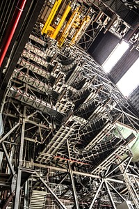 High up in the Vehicle Assembly Building (VAB) at NASA&#39;s Kennedy Space Center in Florida, a crane lowers the second half of the B-level work platforms, B north, for NASA&#39;s Space Launch System (SLS) rocket, for installation in High Bay 3. Original from NASA. Digitally enhanced by rawpixel.