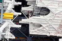 At NASA&rsquo;s Kennedy Space Center in Florida, a crane lowers a space shuttle-era work platform from high bay 3 inside the Vehicle Assembly Building, or VAB. Original from NASA . Digitally enhanced by rawpixel.