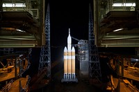 The launch gantry is rolled back to reveal NASA&#39;s Orion spacecraft mounted atop a United Launch Alliance Delta IV Heavy rocket at Cape Canaveral Air Force Station&#39;s Space Launch Complex 37. Original from NASA. Digitally enhanced by rawpixel.