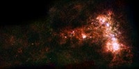 In combined data from ESA&#39;s Herschel and NASA&#39;s Spitzer telescopes, irregular distribution of dust in the Small Magellanic Cloud becomes clear.  Original from NASA. Digitally enhanced by rawpixel.