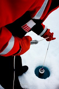 Clark University student Christie Wood lowers a water sampler into a borehole on July 4, 2010. Original from NASA. Digitally enhanced by rawpixel.