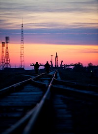 Russian security officers walk along the railroad tracks out to the launch pad Monday, Nov. 11, 2011 at the Baikonur Cosmodrome in Kazakhstan. Original from NASA. Digitally enhanced by rawpixel.