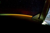 Earth&rsquo;s thin line of atmosphere and a starry sky just off the port wing of the docked space shuttle Endeavour are featured in this image, 28 May 2011. Original from NASA. Digitally enhanced by rawpixel.