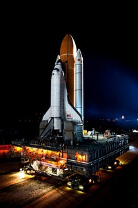Space shuttle Atlantis, attached to its bright-orange external fuel tank and twin solid rocket boosters on Launch Pad 39A at NASA's Kennedy Space Center in Florida. Original from NASA . Digitally enhanced by rawpixel.