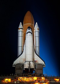 Space shuttle Atlantis, attached to its bright-orange external fuel tank and twin solid rocket boosters on Launch Pad 39A at NASA&#39;s Kennedy Space Center in Florida. Original from NASA . Digitally enhanced by rawpixel.