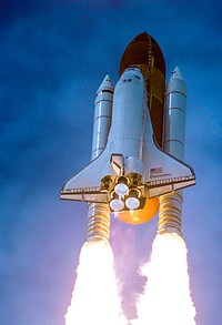 Spewing twin columns of fire from the solid rocket boosters as space shuttle Discovery roars into the blue Florida sky toward space on mission STS-120. Original from NASA. Digitally enhanced by rawpixel.