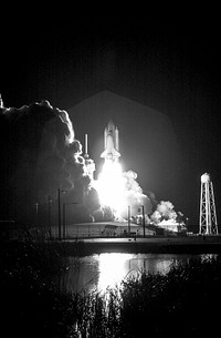 At liftoff from Launch Pad 39B, Space Shuttle Discovery spreads a blaze of light as it leaps into the night sky over Kennedy Space Center. Original from NASA. Digitally enhanced by rawpixel.