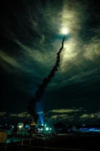 Flooding the night sky with light, Space Shuttle Discovery streaks through the clouds after liftoff from Launch Pad 39B on mission STS-116. Original from NASA . Digitally enhanced by rawpixel.