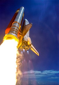Making history with the first-ever launch on Independence Day, Space Shuttle Discovery rockets into the blue sky on mission STS-121, trailing fiery exhaust from the main engine nozzles. Original from NASA. Digitally enhanced by rawpixel.