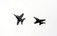 Two F/A-18 jets fly over the Shuttle Landing Facility at NASA's Kennedy Space Center in Florida. Original from NASA. Digitally enhanced by rawpixel.