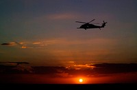 A helicopter patrols the sky over NASA's Kennedy Space Center in Florida before the launch of space shuttle Discovery on the STS-119 mission. Original from NASA. Digitally enhanced by rawpixel.