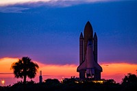 Space shuttle Discovery is silhouetted against the dawn sky as it rolls out to Launch Pad 39A at NASA's Kennedy Space Center in Florida. Original from NASA . Digitally enhanced by rawpixel.