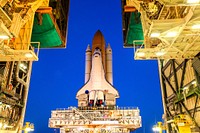 At NASA&#39;s Kennedy Space Center in Florida, space shuttle Discovery begins its nighttime trek, known as rollout, from the Vehicle Assembly Building to Launch Pad 39A. Original from NASA. Digitally enhanced by rawpixel.