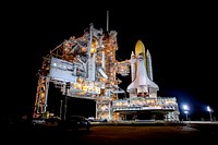 Space shuttle Discovery stands tall on Launch Pad 39A at NASA&#39;s Kennedy Space Center in Florida as space center workers prepare to move the rotating service structure into place. Original from NASA. Digitally enhanced by rawpixel.