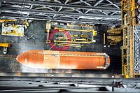 The Space Shuttle Program&#39;s last external fuel tank, ET-122, after it was delivered to the transfer aisle of the Vehicle Assembly Building. Original from NASA . Digitally enhanced by rawpixel.