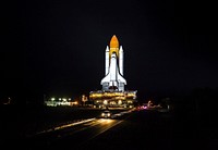 Xenon lights illuminate space shuttle Discovery as it makes its nighttime trek, known as rollout, from the Vehicle Assembly Building to Launch Pad 39A at NASA's Kennedy Space Center in Florida. Original from NASA . Digitally enhanced by rawpixel.