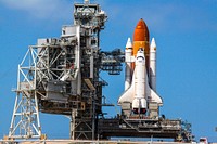 Space shuttle Endeavour glistens in the sun on Launch Pad 39A at NASA's Kennedy Space Center in Florida. Original from NASA. Digitally enhanced by rawpixel.