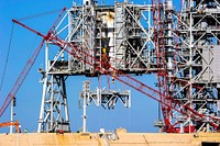 A large crane dismantles another level of the fixed service structure on Launch Pad 39B at NASA's Kennedy Space Center in Florida. Original from NASA . Digitally enhanced by rawpixel.