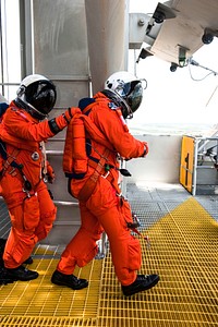During simulated pad emergency exit training on Launch Pad 39A at NASA&#39;s Kennedy Space Center in Florida, the STS-135 crew members make their way toward slidewire baskets that would take them to a safe bunker below the pad in the unlikely event of an emergency. Original from NASA . Digitally enhanced by rawpixel.