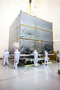 At Astrotech&#39;s Hazardous Processing Facility in Titusville, Fla., technicians use an overhead crane to lift the cover from NASA&#39;s Juno spacecraft. Original from NASA. Digitally enhanced by rawpixel.