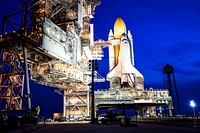 Space shuttle Atlantis, attached to its bright-orange external fuel tank and twin solid rocket boosters on Launch Pad 39A at NASA&#39;s Kennedy Space Center in Florida. Original from NASA . Digitally enhanced by rawpixel.