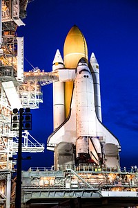 Space shuttle Atlantis, attached to its bright-orange external fuel tank and twin solid rocket boosters on Launch Pad 39A at NASA's Kennedy Space Center in Florida. Original from NASA. Digitally enhanced by rawpixel.