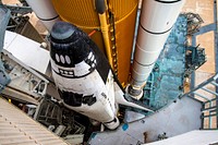 Space shuttle Atlantis, attached to its bright-orange external fuel tank and twin solid rocket boosters on Launch Pad 39A at NASA&#39;s Kennedy Space Center in Florida. Original from <a href="https://www.rawpixel.com/search/NASA?sort=curated&amp;page=1">NASA</a>. Digitally enhanced by rawpixel.