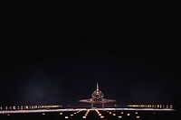 Space shuttle Atlantis begins to disappear into the darkness as it rolls to a stop on Runway 15 on the Shuttle Landing Facility at NASA's Kennedy Space Center in Florida for the final time. Original from NASA . Digitally enhanced by rawpixel.