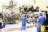 Spacecraft technicians from NASA&#39;s Jet Propulsion Laboratory position the multi-mission radioisotope thermoelectric generator (MMRTG) for NASA&#39;s Mars Science Laboratory (MSL) mission on the turning fixture above the MMRTG integration cart. Original from NASA. Digitally enhanced by rawpixel.