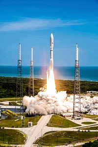Rising from fire and smoke, NASA&#39;s Juno planetary probe, enclosed in its payload fairing, launches atop a United Launch Alliance Atlas V rocket. Original from NASA. Digitally enhanced by rawpixel.