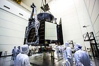 Technicians use an overhead crane to lower NASA Juno spacecraft onto a fueling stand where the spacecraft will be loaded with the propellant necessary for its mission to Jupiter. Original from NASA . Digitally enhanced by rawpixel.